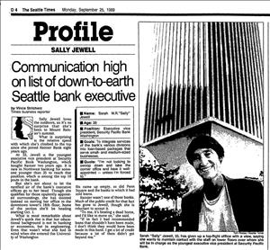 Newspaper clipping of a woman smiling in front of a tall skyscraper and the text Profile Sally Jewell Communication High On List of Down to Earth Seattle Bank Executive. 